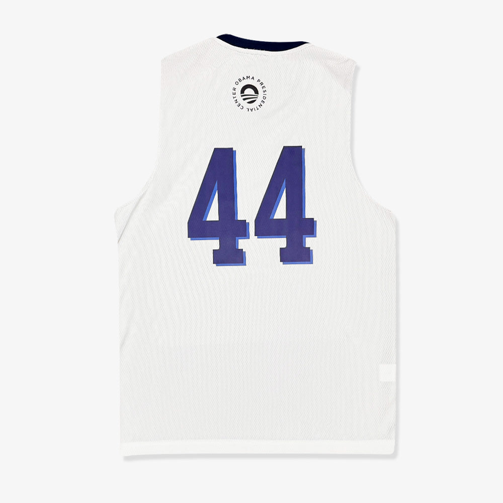 The Obama Presidential Center Home Court Jersey - White features a blue number 44 on the back and a circular logo with text and a wave design near the neckline.