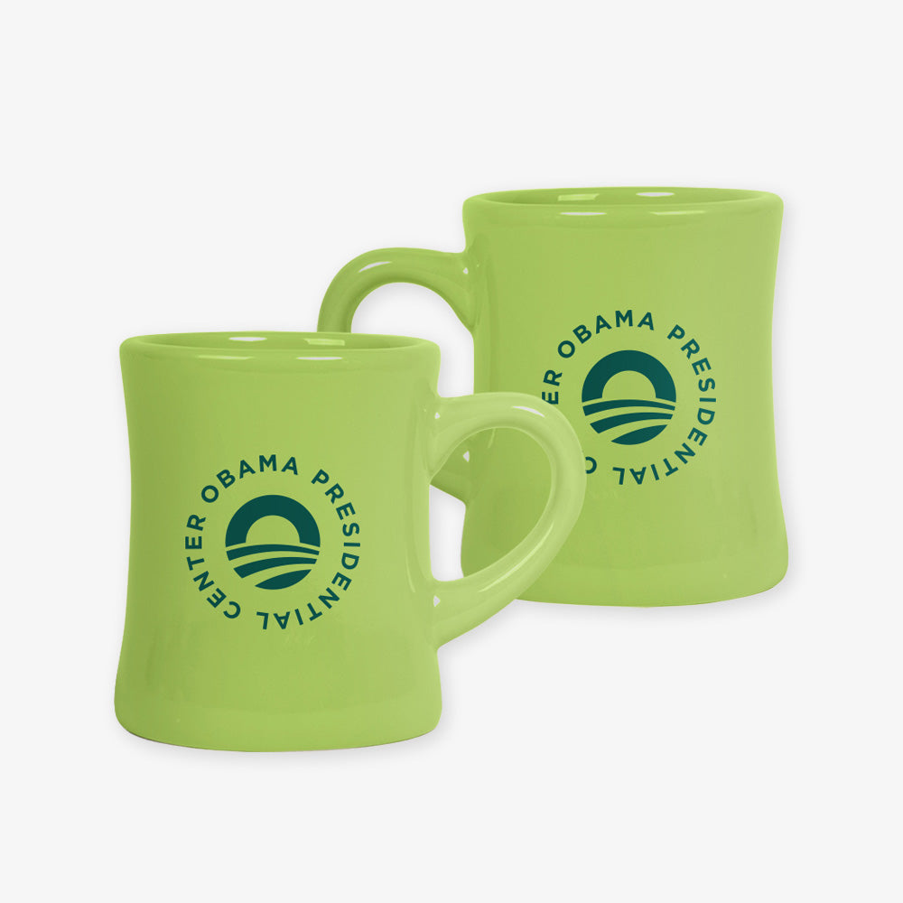 Two Obama Presidential Center Logo Mug, Avocado ceramic mugs, each featuring the center’s logo in dark green.