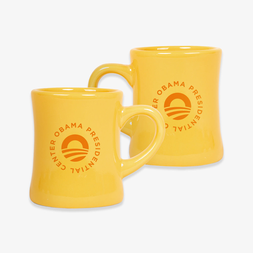 Two Obama Presidential Center Logo Mug, Yellow, each featuring the orange presidential logo.