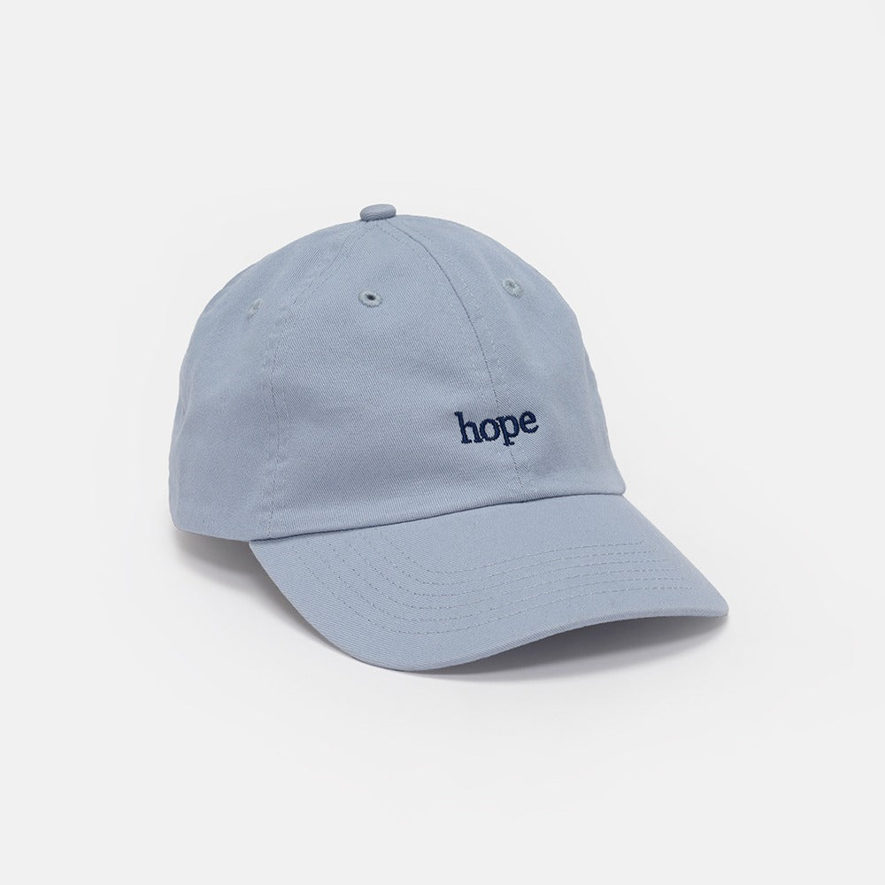 The Obama Presidential Center Hope Cap - Blue features "hope" embroidered in dark blue on the front and is shown against a plain white background.
