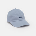 The Obama Presidential Center Hope Cap - Blue features "hope" embroidered in dark blue on the front and is shown against a plain white background.