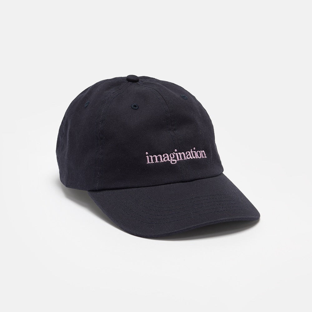 The Obama Presidential Center Imagination Cap is a black baseball cap featuring "imagination" embroidered in white lowercase letters on the front, making it a standout piece of Obama Foundation merchandise.