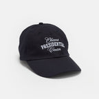 The Obama Presidential Center Embroidered Cap is navy blue with "Obama Presidential Center" in white embroidery on the front, shown against a plain white background.