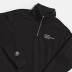 The Obama Presidential Center Quarter Zip Sweatshirt in black features white embroidery on the left chest and the Obama logo on the sleeve cuff—official Obama Foundation merchandise, shown against a white background.