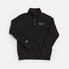 The Obama Presidential Center Quarter Zip Sweatshirt in black features white embroidery on the left chest and a small white logo on the left sleeve. The pullover is shown laid flat on a white background.
