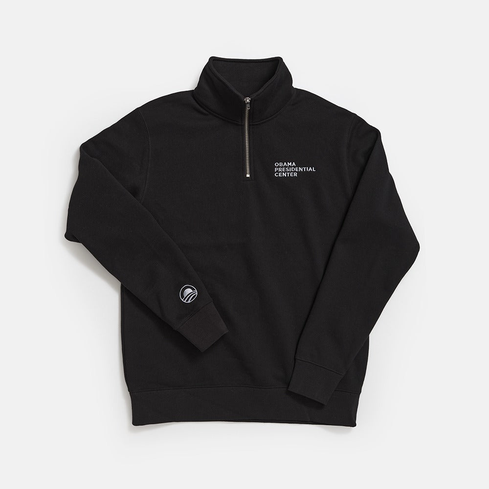 The Obama Presidential Center Quarter Zip Sweatshirt is a black pullover featuring white embroidered logos on the chest and sleeve, displayed flat on a white background.