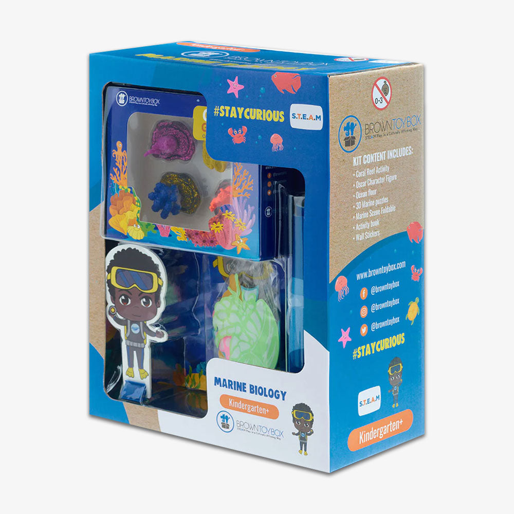The Marine Biology STEAM Kit for kindergarteners includes colorful toy sea animals, a diver cutout, glow-in-the-dark marine life, and comes in underwater-themed packaging with #STAYCURIOUS and contents listed on the side.