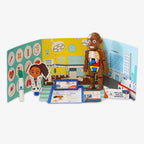The Medical Sciences STEAM Kit includes a hospital backdrop, anatomy doll with removable organs, doctor figure, clipboard, bandages, and medical tools—perfect for educational and imaginative pretend play.