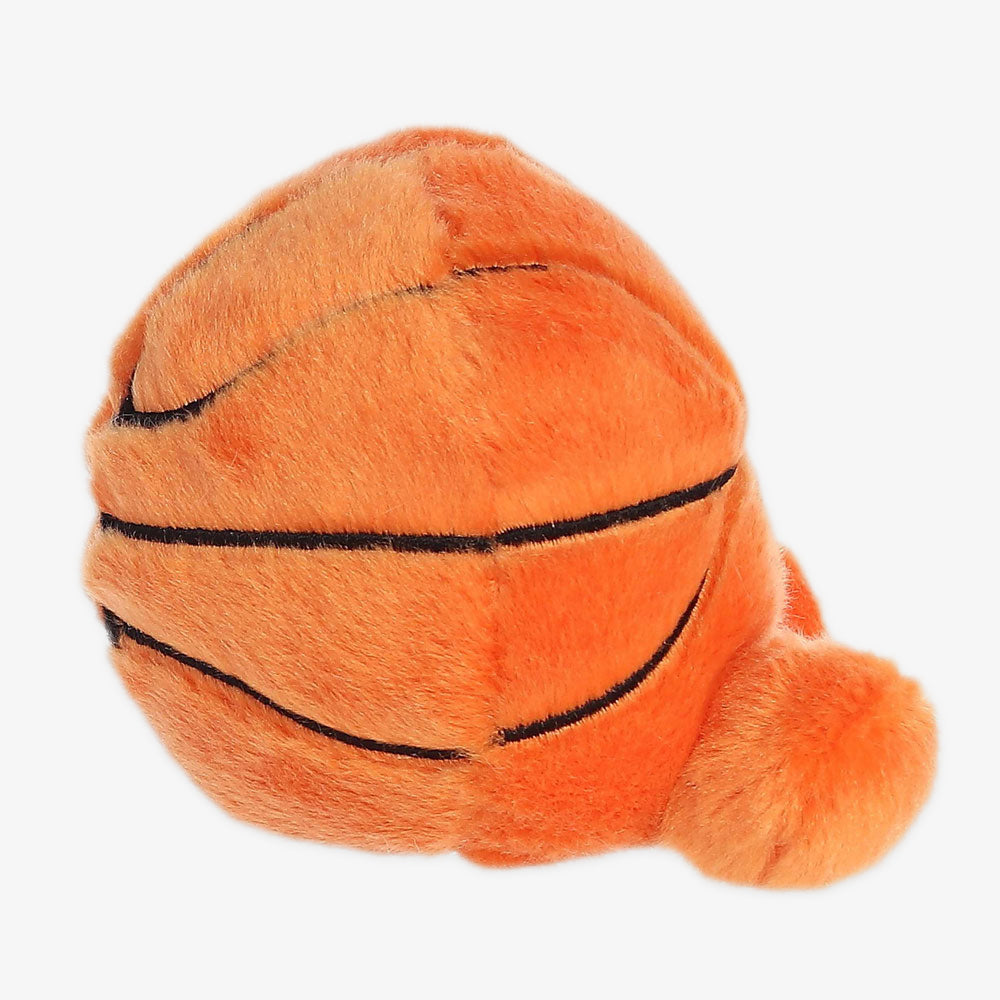 The Palm Pal Hoops Basketball Plush is a soft orange basketball-shaped toy with black lines and a round tuft, inspired by the Obama Presidential Center—a fun keepsake for any fan.