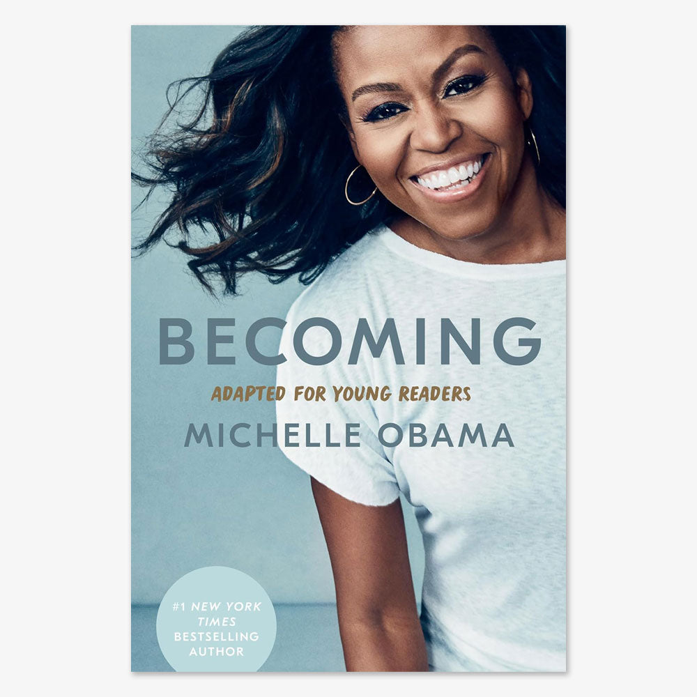 Book cover of Becoming: Adapted for Young Readers by Michelle Obama. She smiles in a white shirt with wind-blown hair. A blue sticker highlights "#1 New York Times Bestselling Author" on this inspiring memoir.