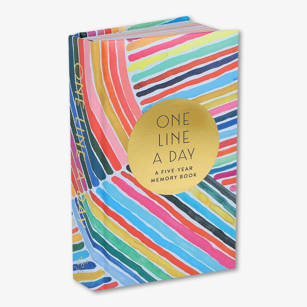 Rainbow One Line a Day: A Five-Year Memory Book is a colorful hardcover journal with diagonal rainbow stripes and a gold circle on the cover, inspired by Kindah Khalidy.
