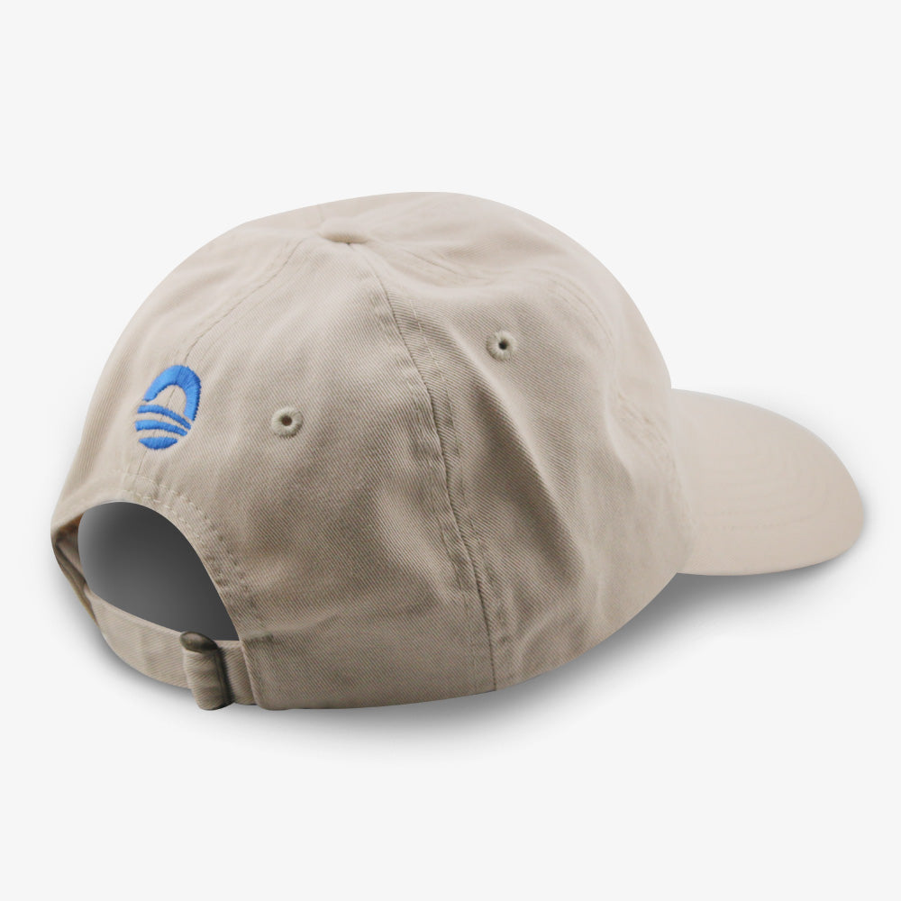 The Obama Presidential Center Hope Cap is beige with an adjustable strap and a small blue logo above the back opening—seen from the rear and side, it’s a stylish piece of official Obama Foundation merchandise.