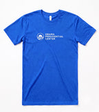The Obama Presidential Center Logo T-shirt - Royal features the white logo and text on the chest, celebrating the Foundation’s South Side work. Displayed flat on a white surface, this royal blue tee shows your support.
