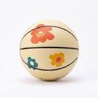 The Obama Presidential Center Floral Basketball features a cream base with red, orange, yellow, and blue flower designs and "We Are The Future" along the bottom edge. Part of the Home Court collection, it is photographed on a white background.