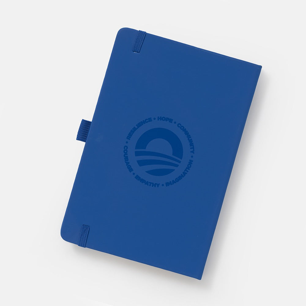 The Obama Presidential Center Hope Journal features a navy blue cover with an embossed circular HOPE wordmark and words like Resilience, Community, Courage, Empathy, and Imagination, shown on a white background.