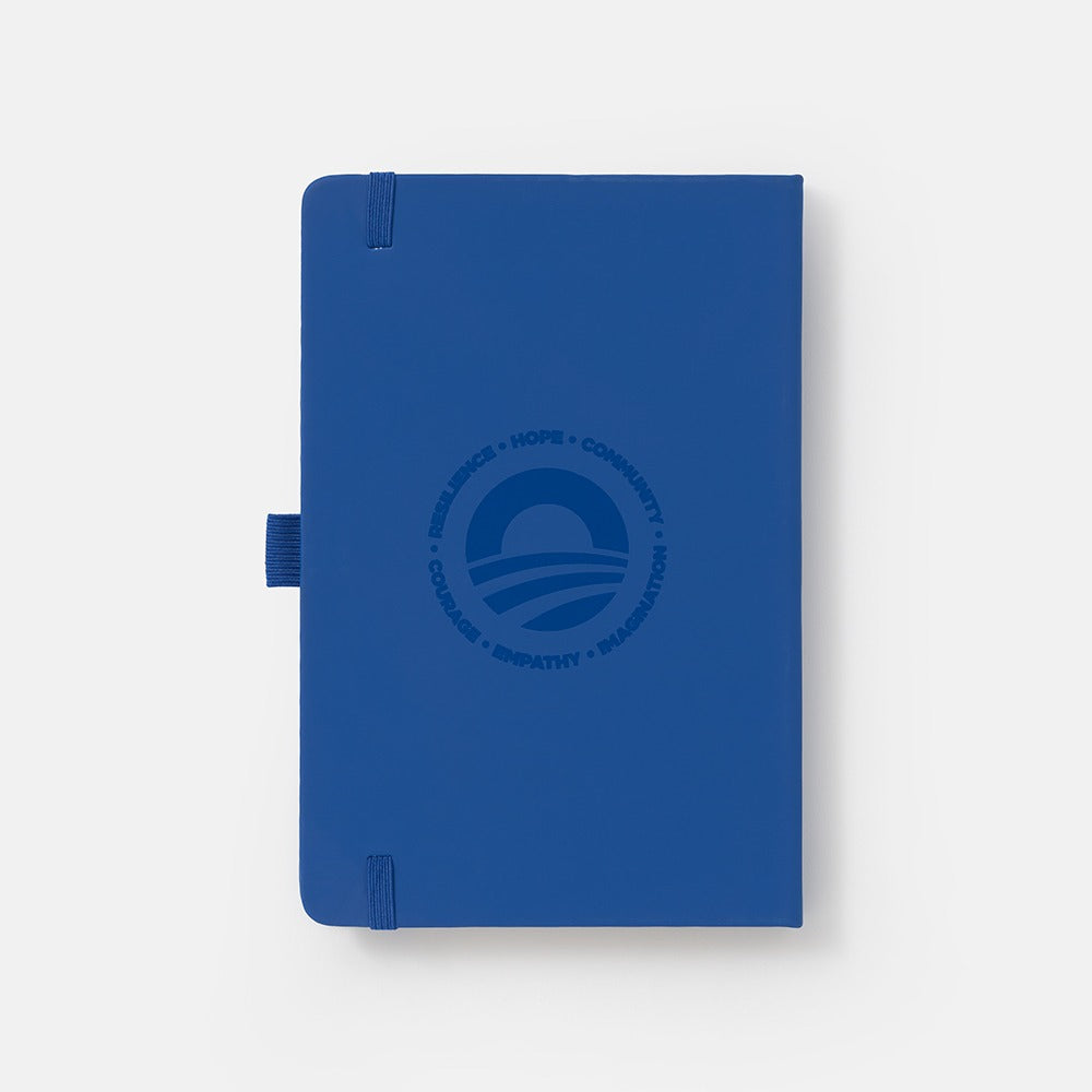 The Obama Presidential Center Hope Journal is a navy blue journal featuring an elastic closure, pen loop, and the HOPE wordmark with "Resilience • Hope • Community • Courage • Empathy • Imagination" embossed on the cover.