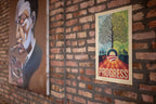 The Official Obama 2008 "Progress" Campaign Poster features a tree growing from the Obama O logo, silhouettes of people, and bold PROGRESS text—an iconic limited-edition print. A painting of a person smoking appears nearby.