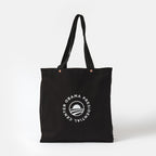The Obama Presidential Center Script Tote is a black canvas bag with two handles, featuring a white circular logo with "Obama Presidential Center" around a stylized O, shown against a plain white background.