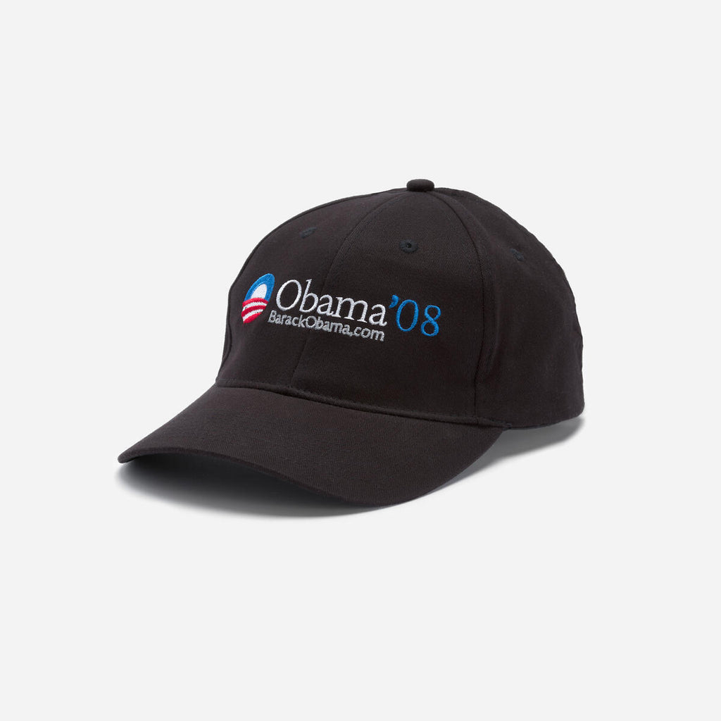 The Official Obama 2008 Campaign Hat - Black features "Obama '08" and "BarackObama.com" embroidered in white and blue, plus a red and white striped circular logo—ideal memorabilia for any Obama Foundation supporter.