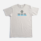The "Yes We Can" T-shirt is a light gray tee featuring the Obama campaign logo above "YES WE DID. YES WE CAN." in bold black and blue, inspired by President Obama's farewell address and supporting the Obama Foundation.