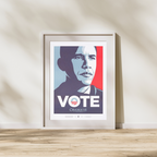 An Official Obama 2008 "Vote" Campaign Poster, framed and featuring a stylized Barack Obama portrait, rests on a wooden floor against a light wall with sunlight casting soft shadows—a must-have piece of campaign memorabilia.